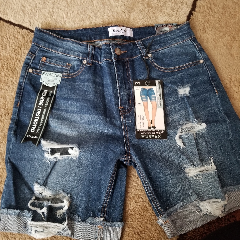 Ripped Bermuda length denim shorts